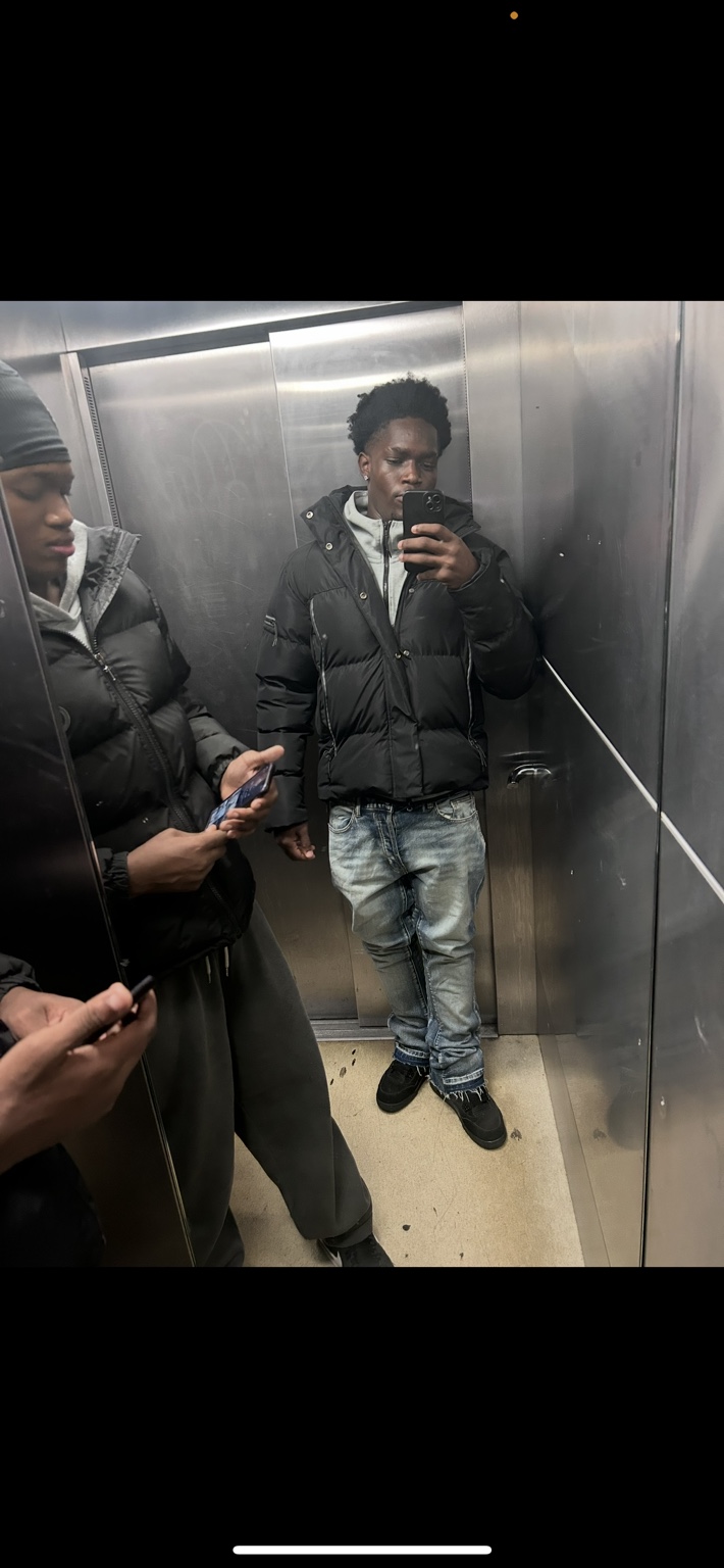 Raphael in a cap and puffer jacket